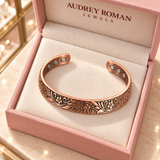 Overhead view of the Florence Vine Bracelet in copper tone in an Audrey Roman Jewels box on the boutique counter.
