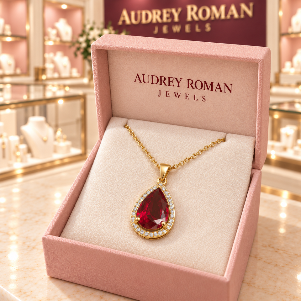 Julia Red Teardrop Pendant Necklace (gold-tone) in a rose Audrey Roman Jewels box inside the boutique.