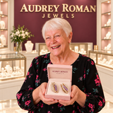 Imogen Earrings (rose-gold-tone) presented in its box by the woman in the Audrey boutique.