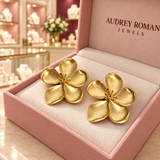 Low oblique front view of the Cassandra flower earrings showing the cupped petals inside the Audrey box in the boutique.