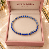 Rosamund Blue Tennis Bracelet | Silver-Tone viewed from above in its Audrey presentation box.